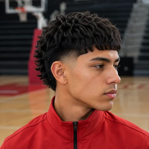 Young man with a burst fade Edgar haircut and textured curly hair, shown in three-quarter profile